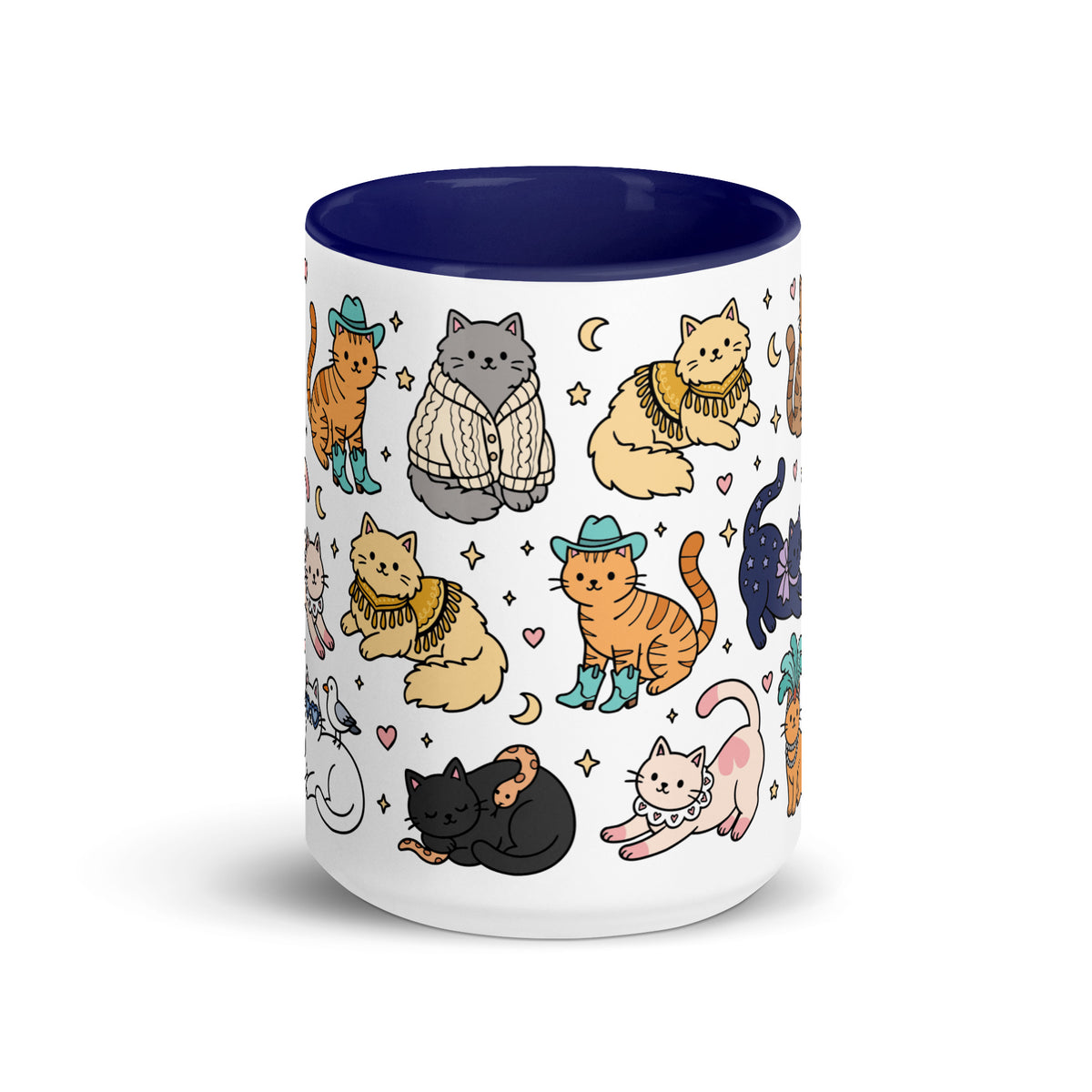 A white ceramic mug with a dark navy blue interior and rim, decorated with a whimsical pattern of illustrated cats in various outfits and colors, set against a plain white background.