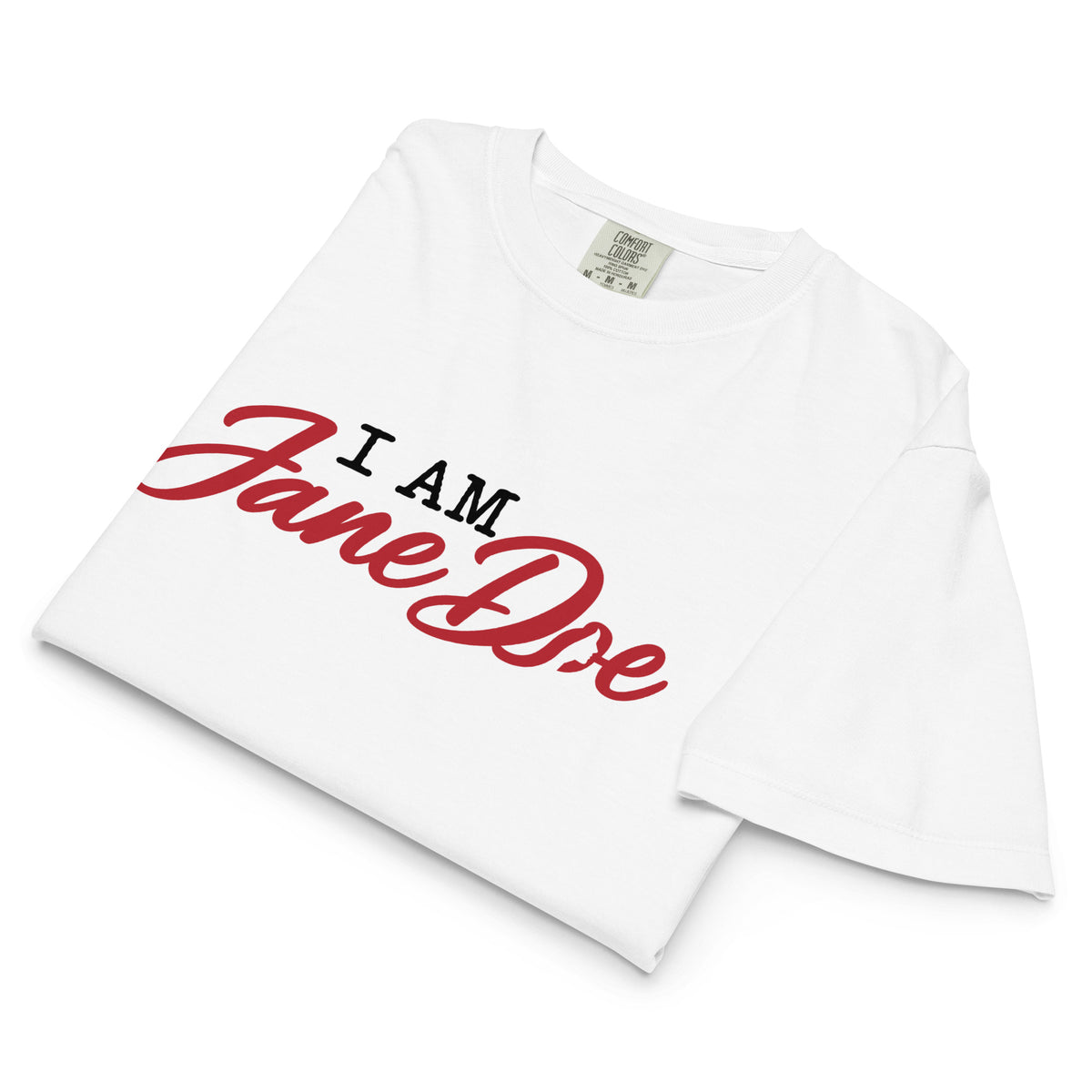 A white short-sleeve t-shirt with 'I AM Jane Doe' printed on the chest. 'I AM' is in black block letters, while 'Jane Doe' is written in a large red cursive script.