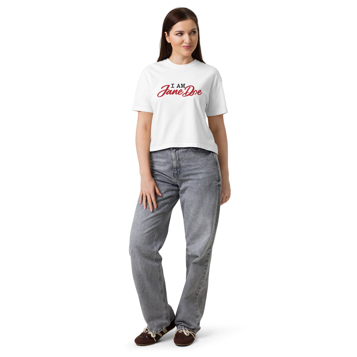 Woman wearing a white t-shirt with blue text and gray jeans on a white background