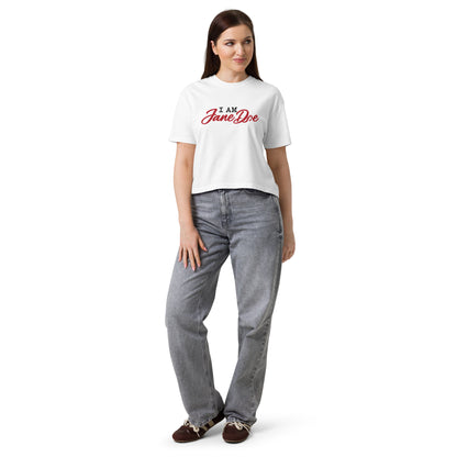 Woman wearing a white t-shirt with blue text and gray jeans on a white background