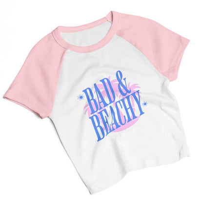 Bad and Beachy Micro Rib Raglan Baby Tee by Spinsterly Co in pink and white with retro palm and flamingo print