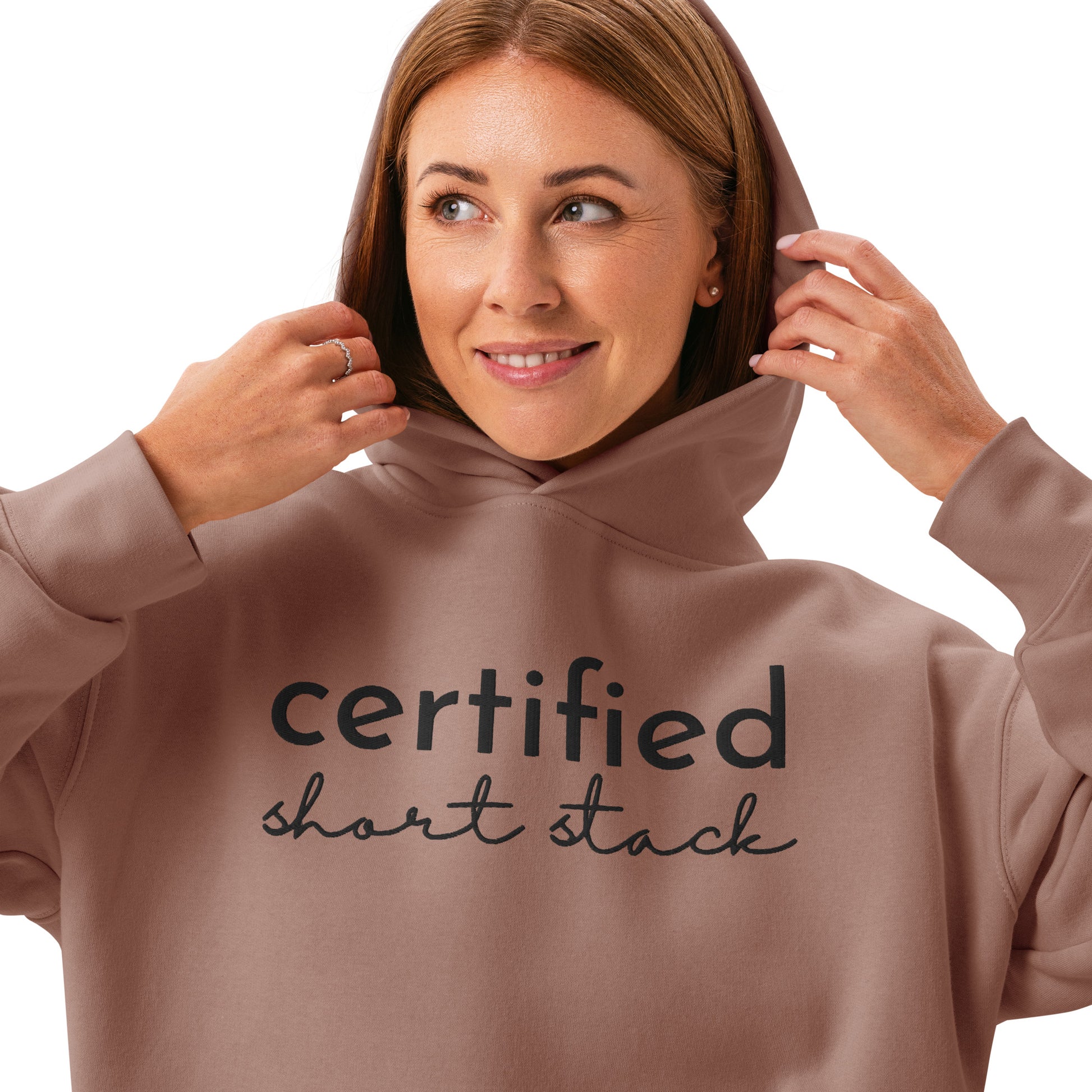 Woman wearing a brown hoodie with 'certified short stack' text on a white background