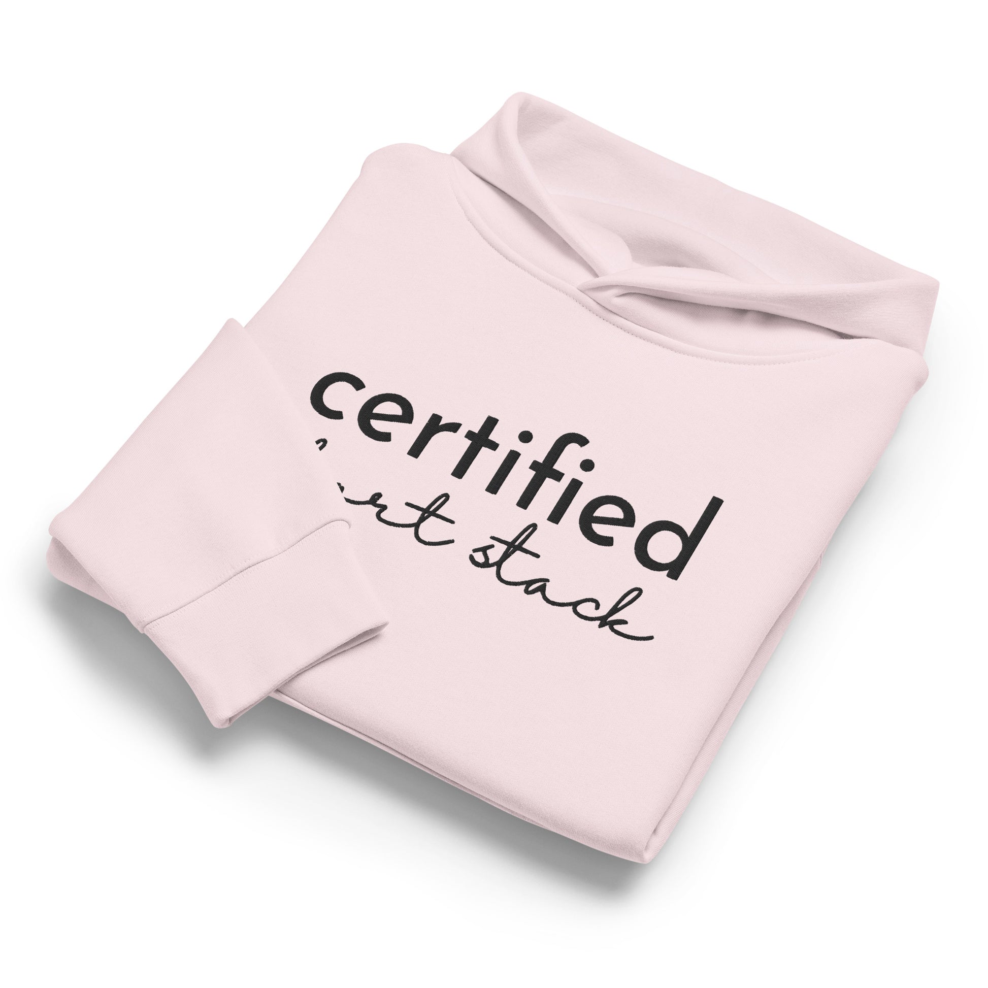 A light pink folded hoodie with black text reading 'certified art stack' on the front, shown on a clean white background.